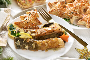 Fried carp fillets with sauerkraut and puff pastry pies with mushrooms for Christmas Eve supper