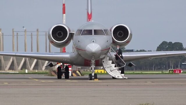 Pilot boarding Private Business Corporate Executive Jet at Regional Airfield Airport