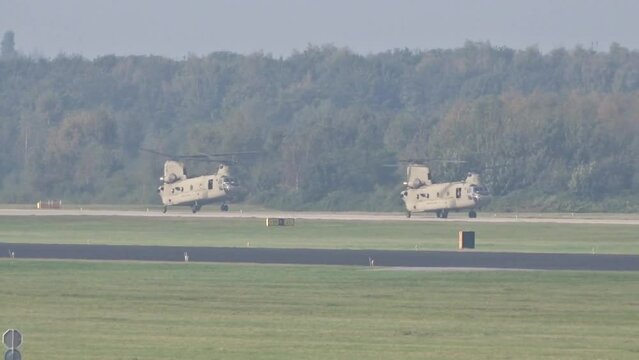 Army Air Force Military Heavy Helicopters Landing at air base after mission.