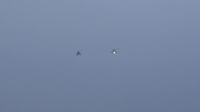 Russian Military Mil Helicopters Approaching in the distance at Air Base