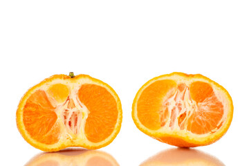Two halves of juicy fresh tangerine, macro, isolated on white background.