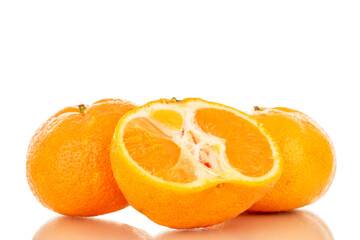 One half and two whole juicy fresh tangerines, macro, isolated on white background.
