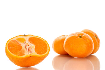One half and three whole juicy fresh tangerines, macro, isolated on white background.