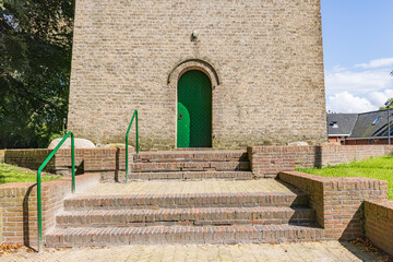 Green entrance door of Protestant church of little village Siddeburen. municipallity...