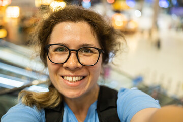 Video call portrait of excited cheerful smiling woman in spectacles taking selfie photo. Selfie and blogger concept - obrazy, fototapety, plakaty