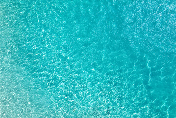 The picture shows a serene blue water background, possibly a calm ocean or lake. The water's...