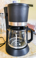 Black coffee maker from Mexico on cream background in kitchen.