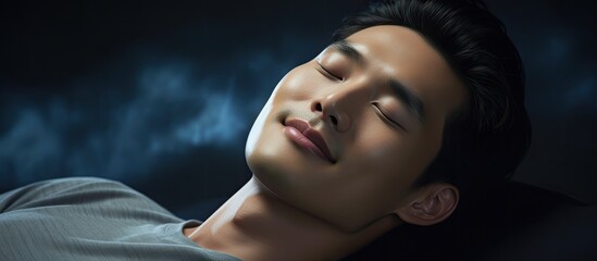 Asian man peacefully sleeps with a nighttime smile in an overhead view. - obrazy, fototapety, plakaty
