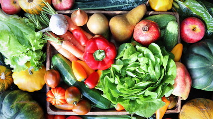 The concept of healthy food. Fresh vegetables, fruits in a wooden box. On a wooden background. Top view. Copy space.