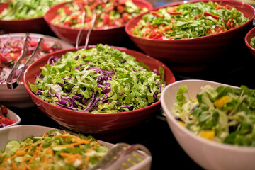 Vibrant salads with fresh veggies on display, shot close-up. The focus on fresh food caters to the trend of health and wellness.