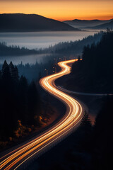 Aerial shot. Light trails at night on a remote mountain road. Drone shot. Long exposure. Vertical photo