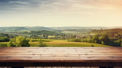 Gordijnen Wooden table with green field summer landscape village wallpaper background © Irina