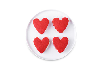 Red velvet whoopie pies in the form of heart for Valentine's day in a plate on a white isolated background