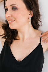 Detail of young woman wearing beautiful luxury earring. Handmade jewellery and accessories