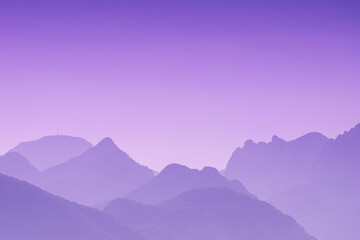 Abstract purple mountains and colorful sky - pink sunset over the landscape - background