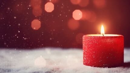 Red Christmas candle on snow with bokeh background. Copy space.