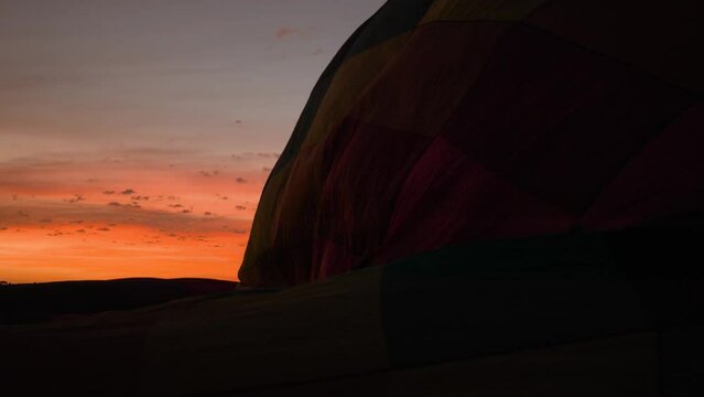 Silhouette Hot air balloons being inflated for flight during a beautiful sunrise in the Serra da Canastra mountains in Minas Gerais, southeastern state of Brazil