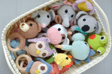 Crochet baby rattle toys in a white basket