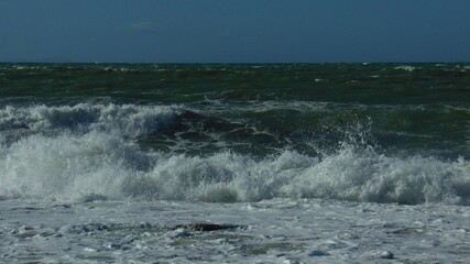 Rough blue sea and foamy waves from the November swells of the Mediterranean