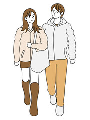 冬の街角を歩く若いカップル