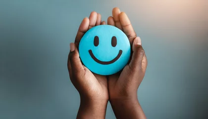 Foto op Plexiglas Hands holding blue happy smile face. mental health positive thinking and growth mindset, mental health care recovery to happiness emotion. © Merlin