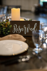 reserved sign with place setting on table for wedding event