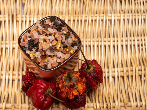 Pink himalayan salt chrystals with dried seeds of red hot chili peppers and herbs, cooking with exotic salt