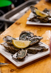 Catch of the day for sale on daily fish market, fresh oysters, Cancale, Brittany, France