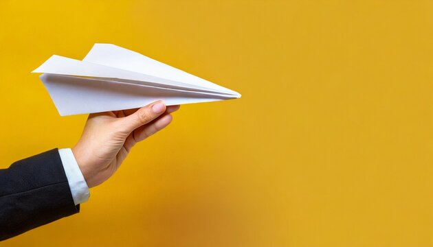 hand holding paper plane over yellow background panoramic mock up image