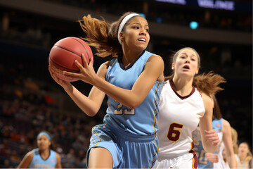 A focused female basketball player in action on an indoor court during a competitive game, showcasing determination and athleticism.