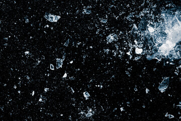 Ice cubes crush on a black background. Chill backdrop. - obrazy, fototapety, plakaty
