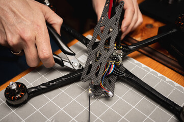 soldering, assembling, IC part of fpv drone esc part assembled by man. Close-up view, high...