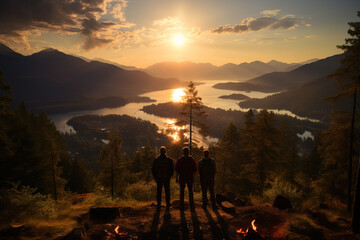 Three friends stand by a campfire, silhouetted against a stunning sunset over a mountainous lakeside.