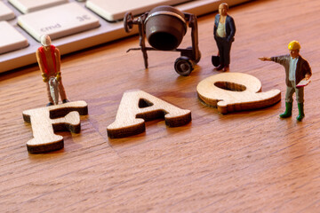 faq word or concept made by wooden letters on wooden background, frequently asked questions...