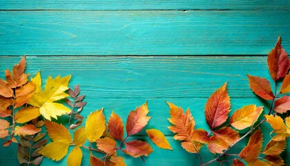 autumn leaves over turquoise wooden background with empty space