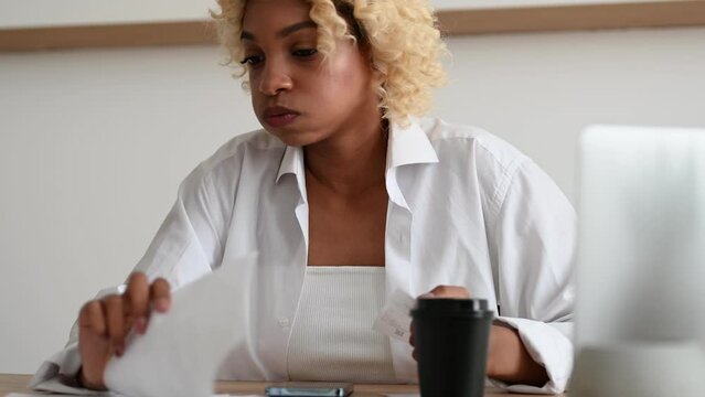 shocked woman looking at the bills to pay. Expenses,credit card statements. Debt,bankruptcy, loan concept