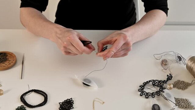 Closeup of woman's hands tatting. handmade jewelry concept