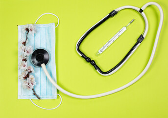 Medical instruments and protective equipment on a green background