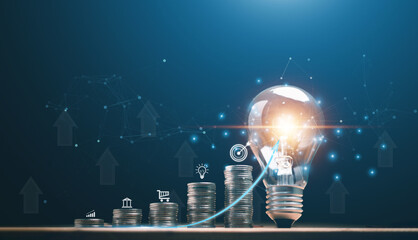 Stack of coins on wooden table with arrows up and business growing arrow graph up to lightbulb....