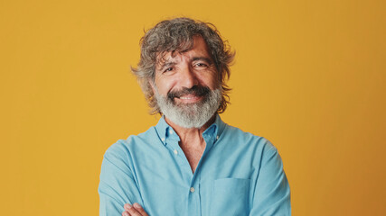 Close-up of an elderly grey-haired bearded man wearing a blue shirt looking camera, isolated on...