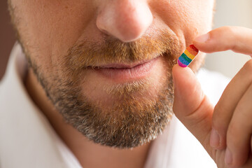 Man holding tablet with LGBT flag colors, gender equality