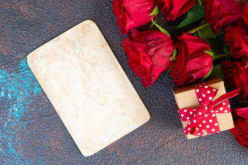Crimson red rose flowers bouquet with gift box and epmty car for text, Valentine's Day background