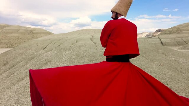 Semazen (dervish) is dancing in the traditional red dress. Whirling dervish in red traditional dress is spinning in awe.