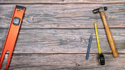 Overhead view of hand tools on a wood work bench.