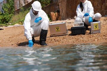 Male and female biologists analyze water test results and keep  samples for examining 