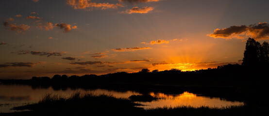 Sunrays trying to hang on to the day as the sunsets over Edward Medard Park in Plant City Florida