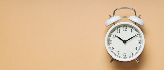 Classic Alarm Clock on Beige Background, Time Concept