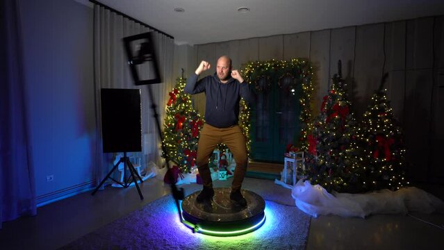 male on bullet-time photospot attraction posing and dancing barrel roll slow motion 360 degrees shot.