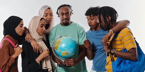 A diverse group of students is gathered around a globe, engrossed in exploration and study, their...