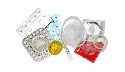 Contraceptive pills, condoms and thermometer isolated on white, top view. Different birth control...